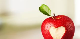 Odkryj codzienne nawyki, które wesprą zdrowie twojego serca czerwone jabłko z wyciętym symbolem czerwonego serca