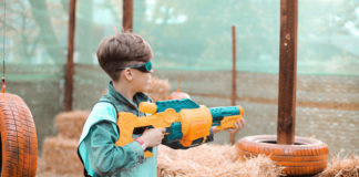 Bezpieczne zabawki militarne – jak je znaleźć? chłopiec z zabawkową wyrzutnią