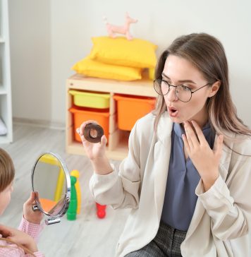 Kiedy z dzieckiem do logopedy? dziewczynka u logopedy