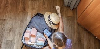 Basen a zdrowie – po co potrzebne są na basenie klapki dziecięce? dziecko pakujące klapki na basen do walizki