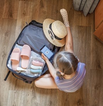 Basen a zdrowie – po co potrzebne są na basenie klapki dziecięce? dziecko pakujące klapki na basen do walizki