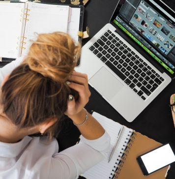 Jakie suplementy stosować na uspokojenie? Jak wybrać skuteczne tabletki na nerwy? zdenerwowana kobieta przed laptopem